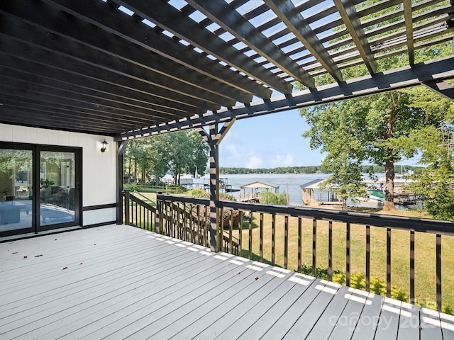 wooden deck with a yard, a water view, and a pergola