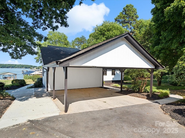 exterior space featuring concrete driveway and a water view