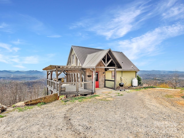 view of front of property featuring a mountain view and metal roof