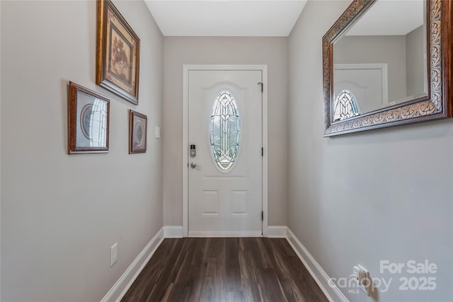 doorway to outside featuring baseboards and dark wood-style flooring