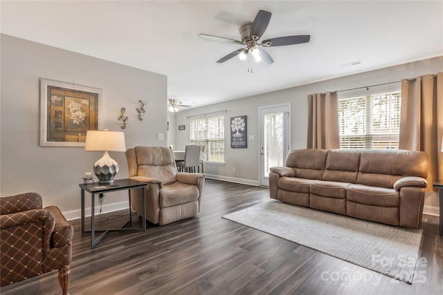 living room with baseboards, dark wood-style floors, visible vents, and ceiling fan