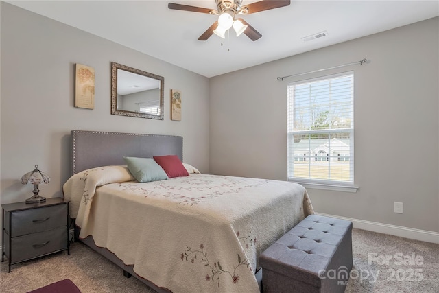 bedroom featuring baseboards, visible vents, a ceiling fan, and light carpet