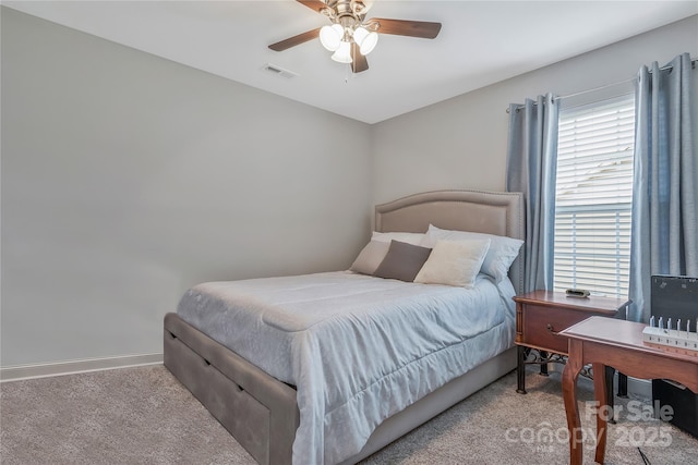 carpeted bedroom with a ceiling fan, baseboards, and visible vents