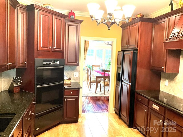 1832 Marthas Vineyard Rd, York, SC 29745 - kitchen featuring a notable chandelier, dobule oven black, dark stone countertops, paneled refrigerator, and tasteful backsplash