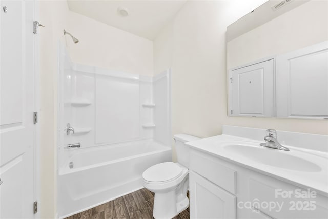 full bathroom featuring visible vents, wood finished floors, toilet, vanity, and  shower combination