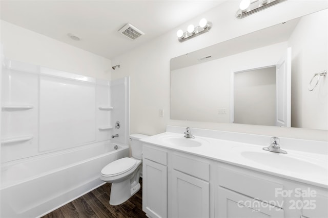 full bath featuring visible vents, wood finished floors, toilet, and a sink