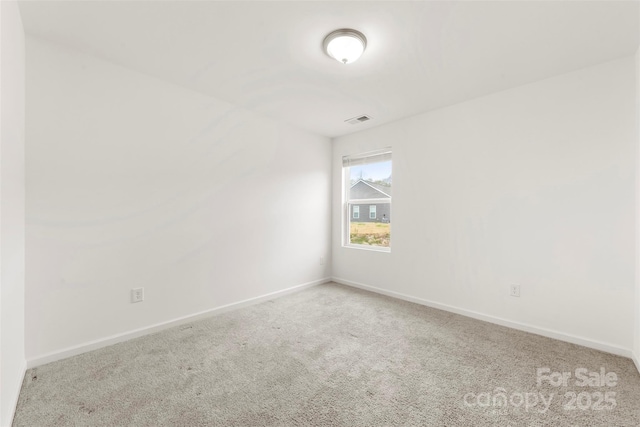 carpeted empty room with baseboards and visible vents