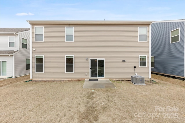 back of property with central air condition unit and a patio