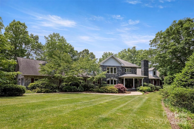 421 N Boundary Rd, Mill Spring, NC 28756 - rear view of house with a lawn, stone siding, and a chimney