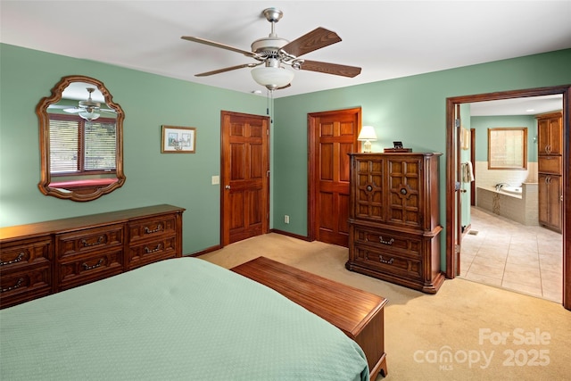 421 N Boundary Rd, Mill Spring, NC 28756 - bedroom featuring light colored carpet, multiple windows, a ceiling fan, and ensuite bathroom