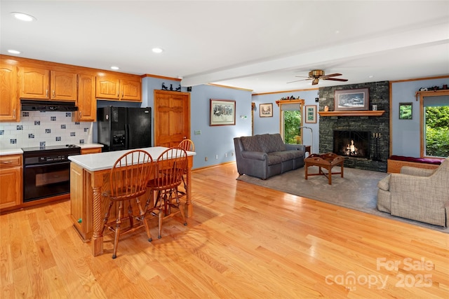 421 N Boundary Rd, Mill Spring, NC 28756 - kitchen featuring black appliances, under cabinet range hood, light wood-style flooring, open floor plan, and recessed lighting