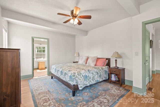 bedroom with baseboards, visible vents, and light wood-style floors