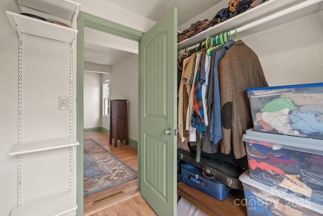 spacious closet with visible vents and wood finished floors