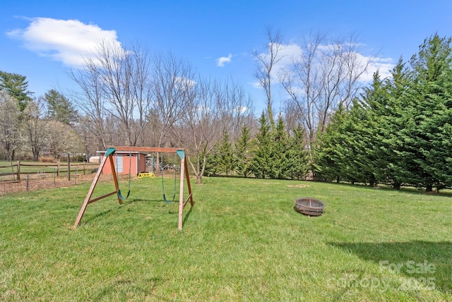view of yard featuring a fire pit and a playground