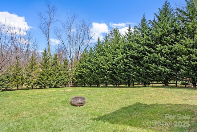 view of yard with a fire pit