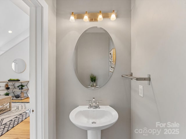 bathroom with a sink and wood finished floors