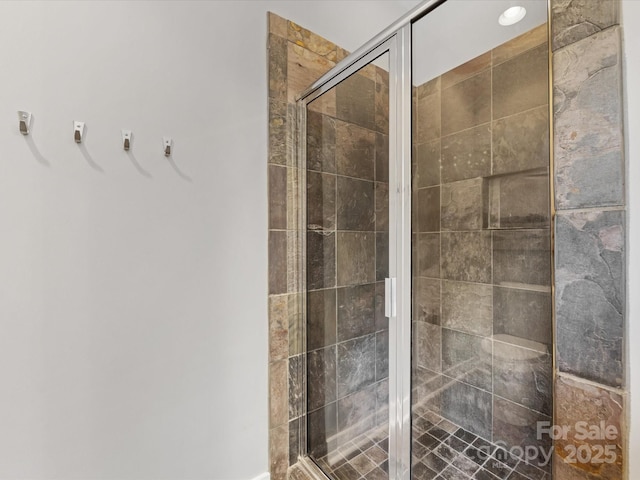bathroom featuring a shower stall