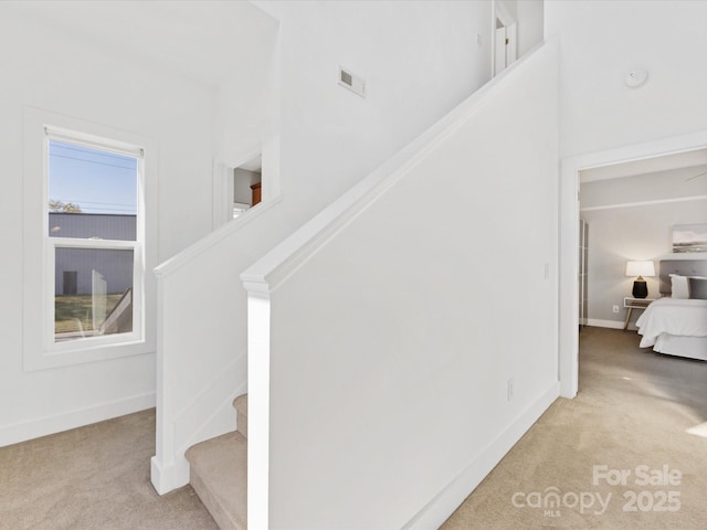 stairs featuring baseboards, carpet, and visible vents