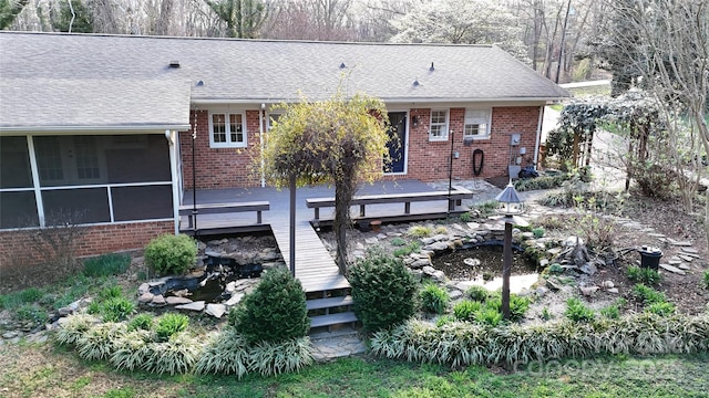 116 Jonas Dr, Lincolnton, NC 28092 - back of property with a wooden deck, a sunroom, brick siding, and roof with shingles