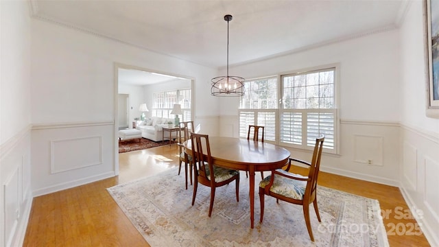 116 Jonas Dr, Lincolnton, NC 28092 - dining area featuring a decorative wall, light wood-style flooring, a notable chandelier, and wainscoting