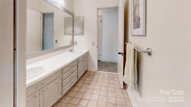 116 Jonas Dr, Lincolnton, NC 28092 - bathroom featuring baseboards, double vanity, a sink, and tile patterned floors