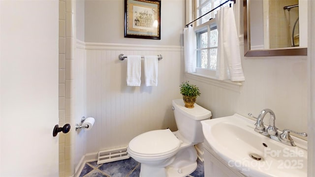 116 Jonas Dr, Lincolnton, NC 28092 - bathroom with a baseboard radiator, wainscoting, toilet, and a sink