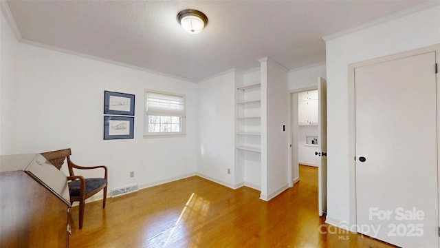 116 Jonas Dr, Lincolnton, NC 28092 - sitting room with visible vents, baseboards, ornamental molding, wood finished floors, and built in features