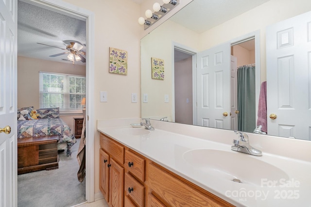 ensuite bathroom featuring ceiling fan and double vanity