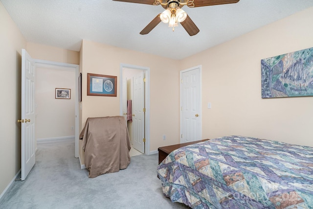 bedroom with light carpet, ceiling fan, and baseboards