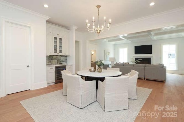 3119 Knowlton Ln, Charlotte, NC 28205 - dining room featuring wine cooler, bar area, a chandelier, light wood-type flooring, and recessed lighting