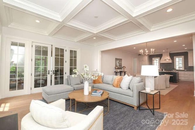 3119 Knowlton Ln, Charlotte, NC 28205 - living room featuring french doors, light wood-style floors, a chandelier, beam ceiling, and coffered ceiling