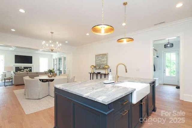 3119 Knowlton Ln, Charlotte, NC 28205 - kitchen with light wood-style floors, decorative light fixtures, a sink, ornamental molding, and light stone countertops