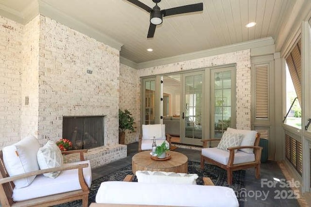 3119 Knowlton Ln, Charlotte, NC 28205 - living room featuring a ceiling fan, ornamental molding, french doors, an outdoor brick fireplace, and brick wall