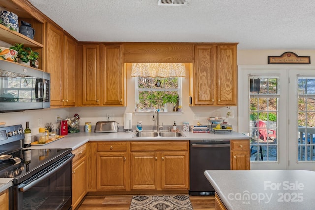 12 Hutchinson Woods Dr, Fletcher, NC 28732 - kitchen featuring stainless steel appliances, light countertops, open shelves, a sink, and a textured ceiling