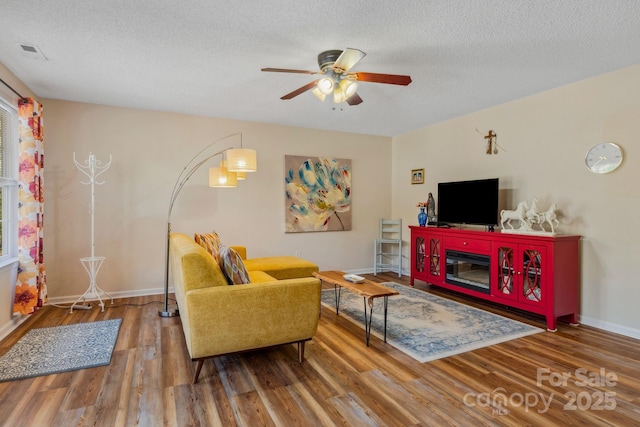 12 Hutchinson Woods Dr, Fletcher, NC 28732 - living area featuring a ceiling fan, wood finished floors, a textured ceiling, baseboards, and visible vents