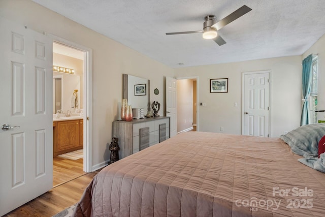 12 Hutchinson Woods Dr, Fletcher, NC 28732 - bedroom with a ceiling fan, connected bathroom, and light wood-style floors