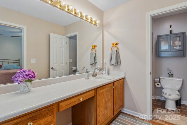 12 Hutchinson Woods Dr, Fletcher, NC 28732 - bathroom featuring toilet, vanity, wood finished floors, and baseboards