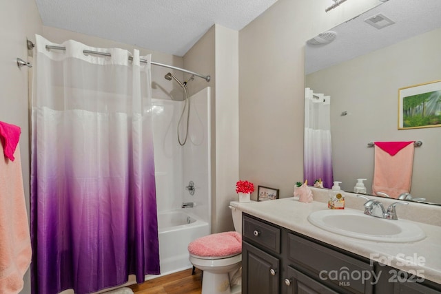 12 Hutchinson Woods Dr, Fletcher, NC 28732 - full bath with wood finished floors, a textured ceiling, vanity, toilet, and visible vents