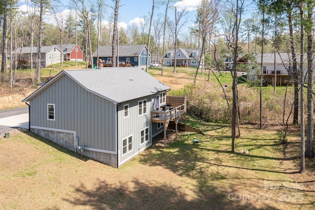 209 Fall Leaves Dr, Fairview, NC 28730 - view of side of home featuring a residential view, board and batten siding, a wooden deck, and a shingled roof