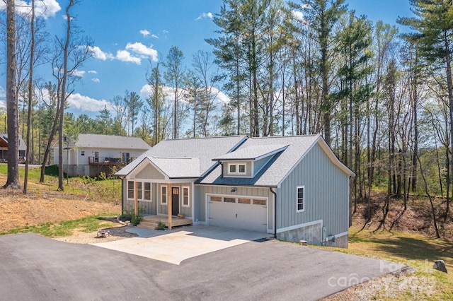 209 Fall Leaves Dr, Fairview, NC 28730 - modern farmhouse featuring asphalt driveway, a garage, roof with shingles, and board and batten siding