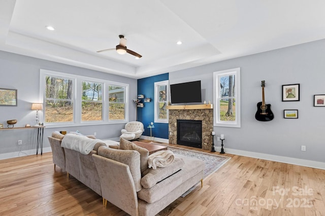 209 Fall Leaves Dr, Fairview, NC 28730 - living room featuring a tray ceiling, wood finished floors, a ceiling fan, a fireplace, and recessed lighting