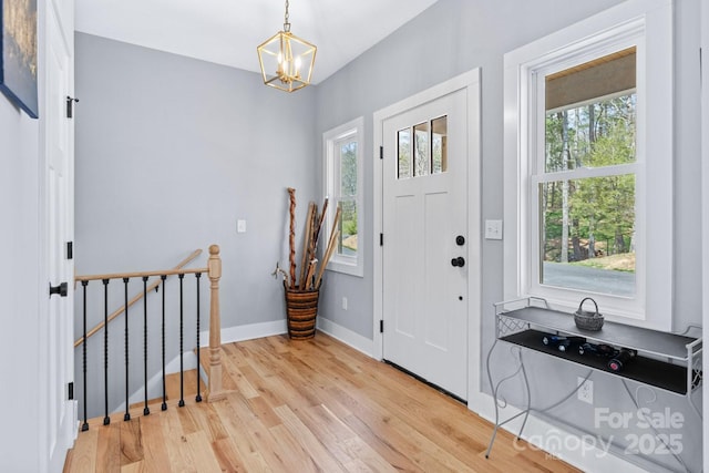 209 Fall Leaves Dr, Fairview, NC 28730 - entrance foyer featuring healthy amount of natural light, wood finished floors, and a chandelier