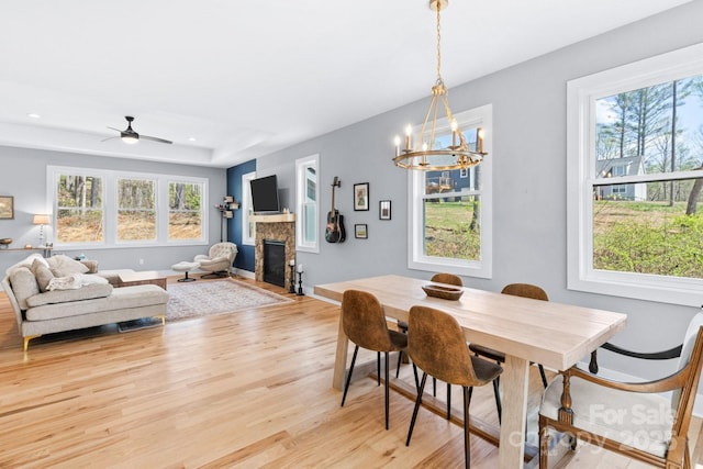 209 Fall Leaves Dr, Fairview, NC 28730 - dining space with a glass covered fireplace, light wood finished floors, a chandelier, recessed lighting, and ceiling fan