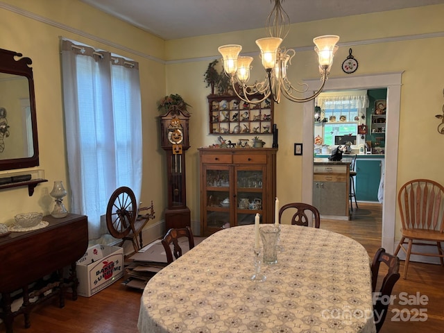 212 S Mitchell Ave, Bakersville, NC 28705 - dining area with an inviting chandelier and dark wood finished floors