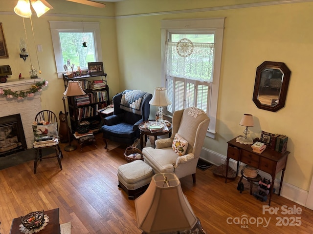 212 S Mitchell Ave, Bakersville, NC 28705 - living area featuring wood finished floors, ceiling fan, a fireplace, and baseboards