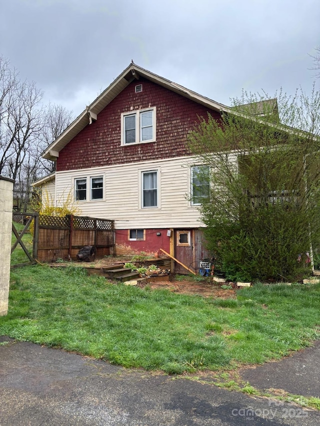 212 S Mitchell Ave, Bakersville, NC 28705 - view of property exterior featuring fence and a lawn