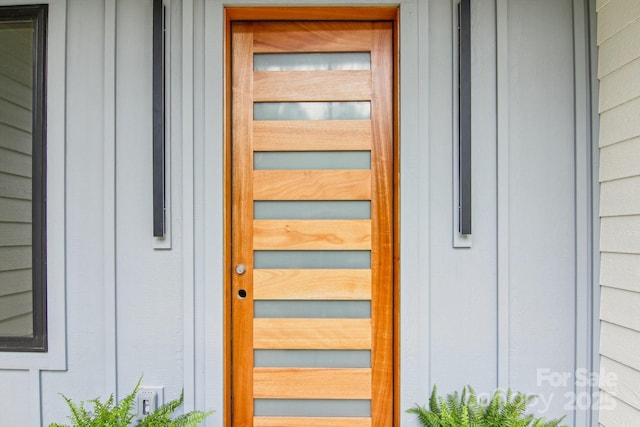 entrance to property featuring board and batten siding