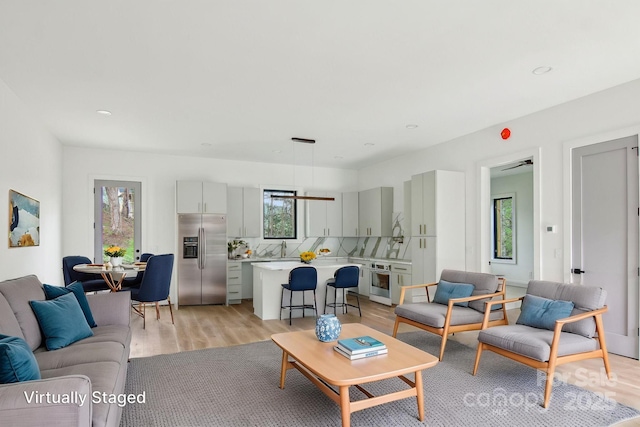 living room with recessed lighting and light wood-type flooring