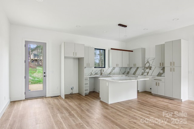 kitchen with a healthy amount of sunlight, a center island, and gray cabinets