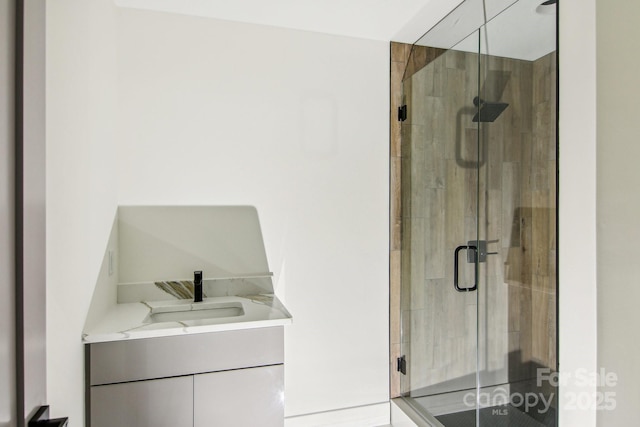 full bathroom featuring vanity and a shower stall